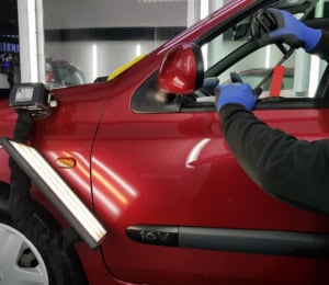 Paintless dent removal on car door by MAX WAX