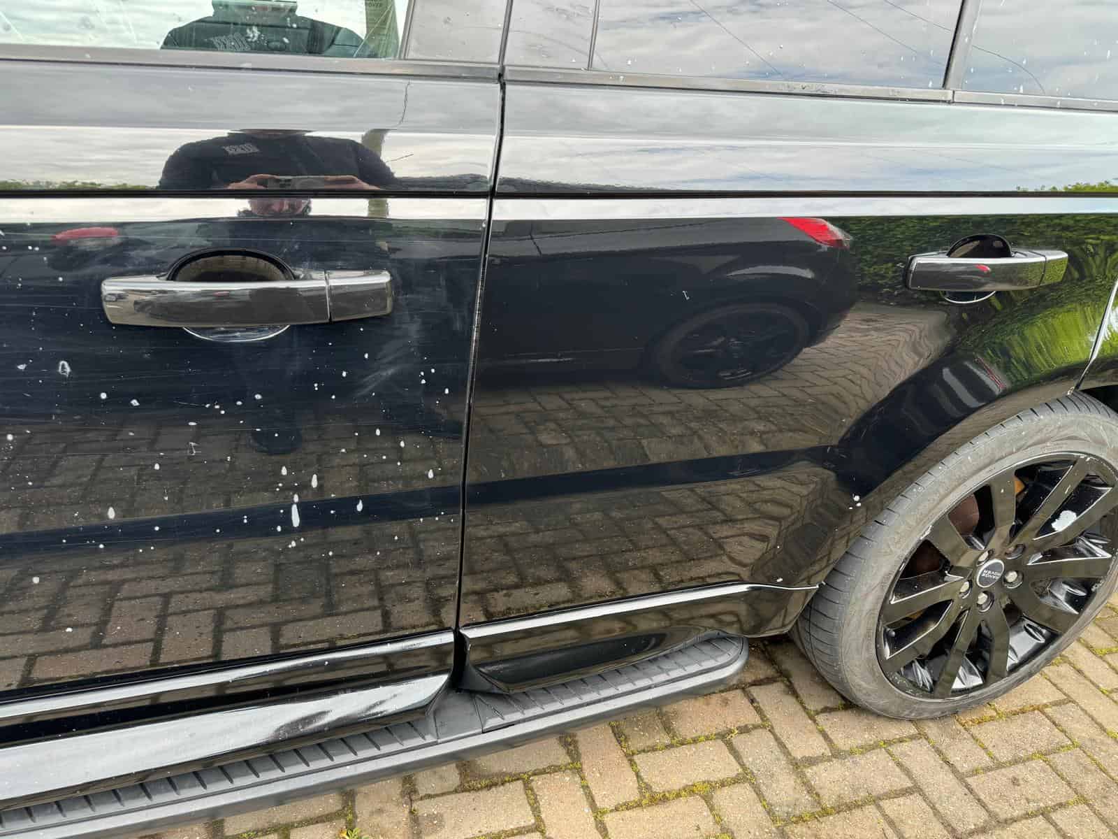 Car paint contamination removal: severe widespread paint contamination across a customer vehicle's panels and wheels handled by MAX WAX