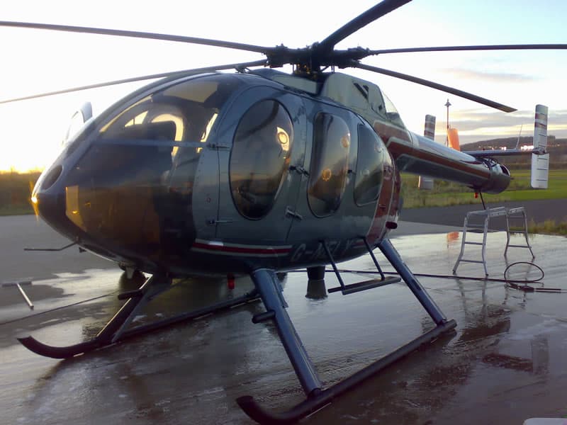 Helicopter being washed at sunset at Brighton City Airport