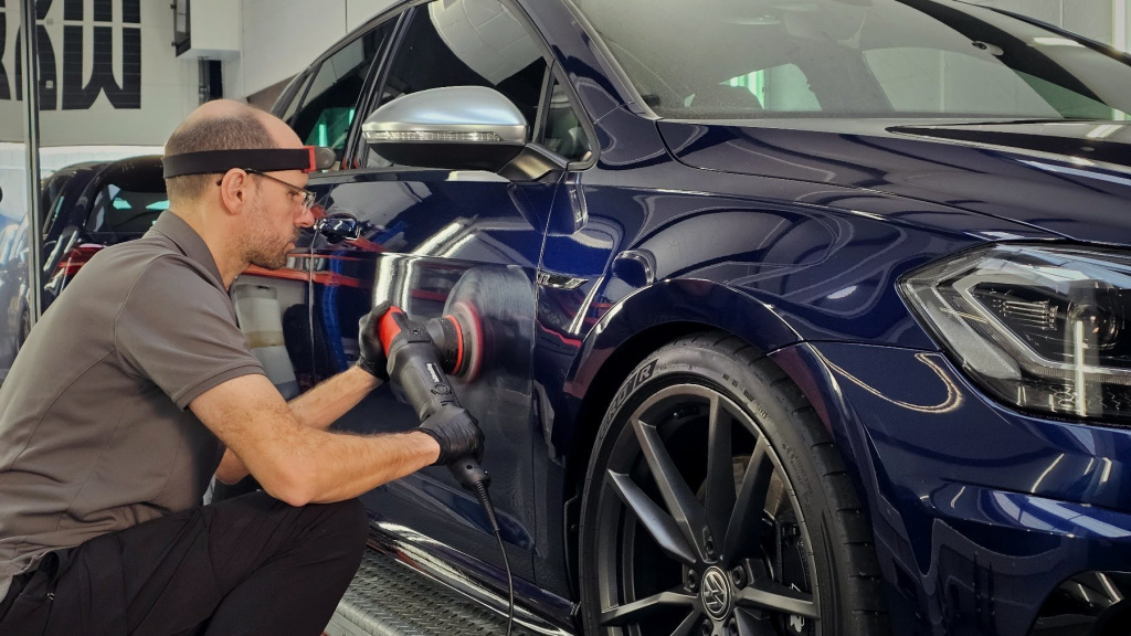 MAX WAX technician machine polishing a car during paint correction