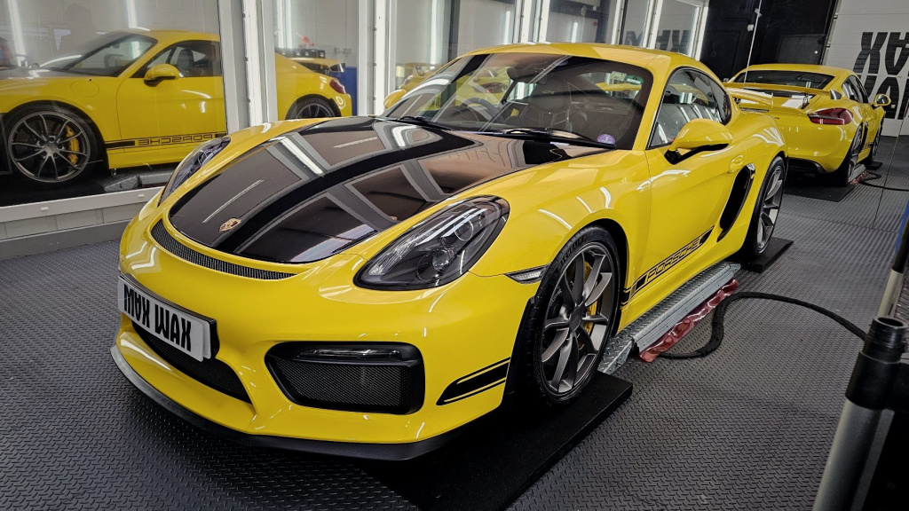 Yellow Porsche Cayman inside the MAX WAX detailing studio