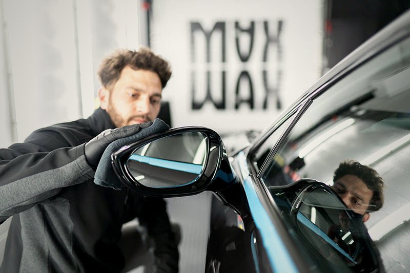 MAX WAX technician with a BMW i8 in the studio